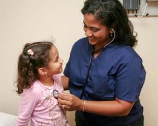 Nurse takes heartbeat of young patient with stethoscope | Granville Health System