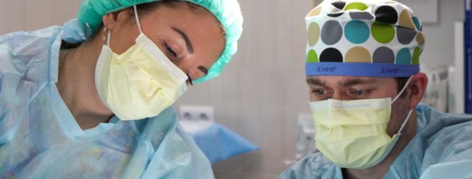 Picture of healthcare providers in surgical masks performing an operation | Granville Health System