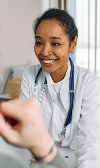 Healthcare professional smiles while talking to patient | Granville Health System