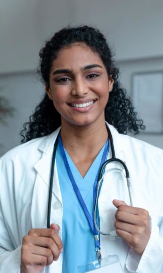 Doctor in lab coat with her hands on her stethoscope | Granville Health System