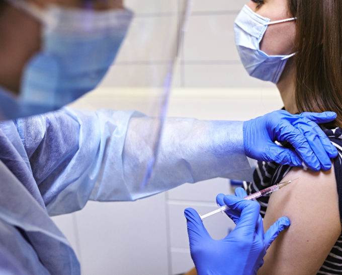Close Up Of A Doctor Making A Vaccination In The Shoulder Of Pat Doctor giving a shot to a patient, with both of them wearing masks | Granville Health System