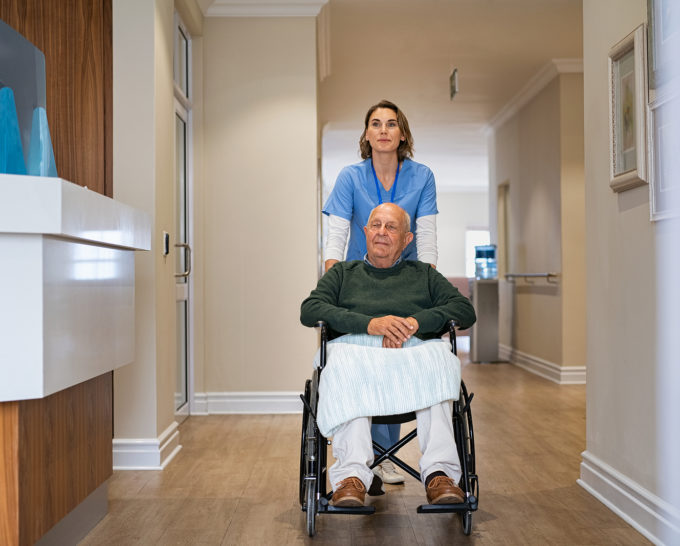 Nurse pushes elderly patient in wheelchair | Granville Health System